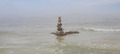 волны били её нещадно, но башня выстояла